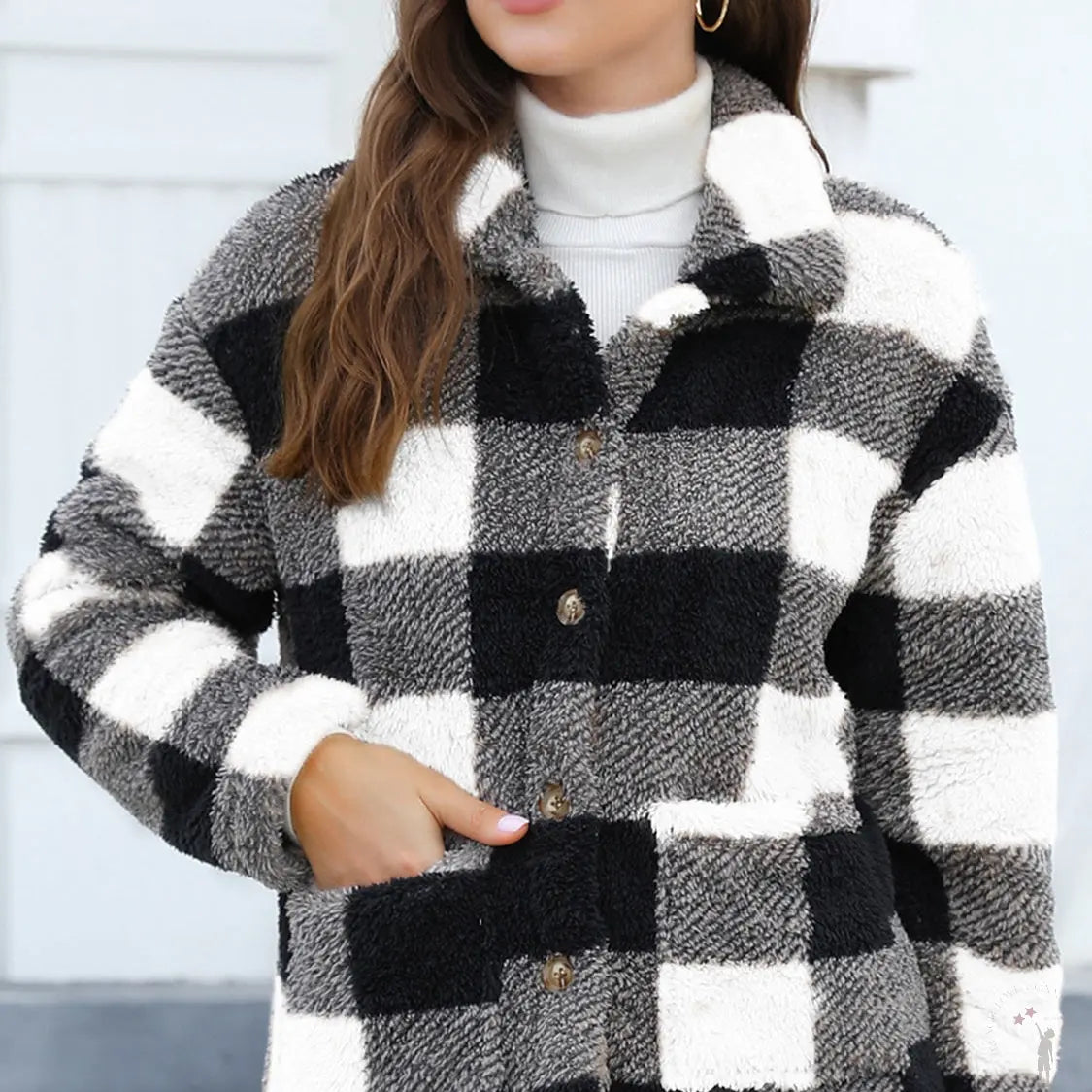 Person wearing a black and white checkered jacket with a blurred background