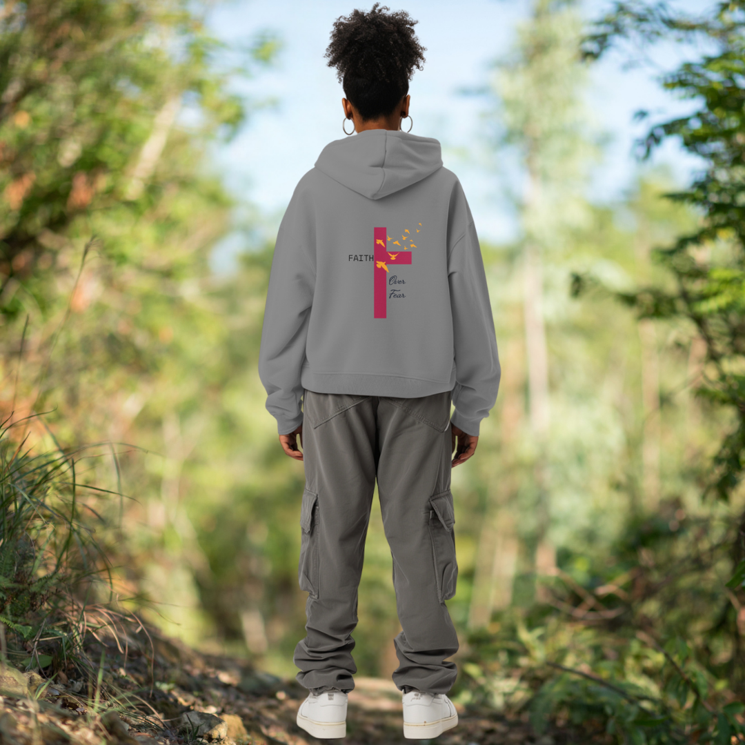 Model wearing the Faith Over Fear Hoodie from Reach Love Connect – bold Christian statement hoodie with inspiring text, symbolizing strength, trust, and spiritual courage.