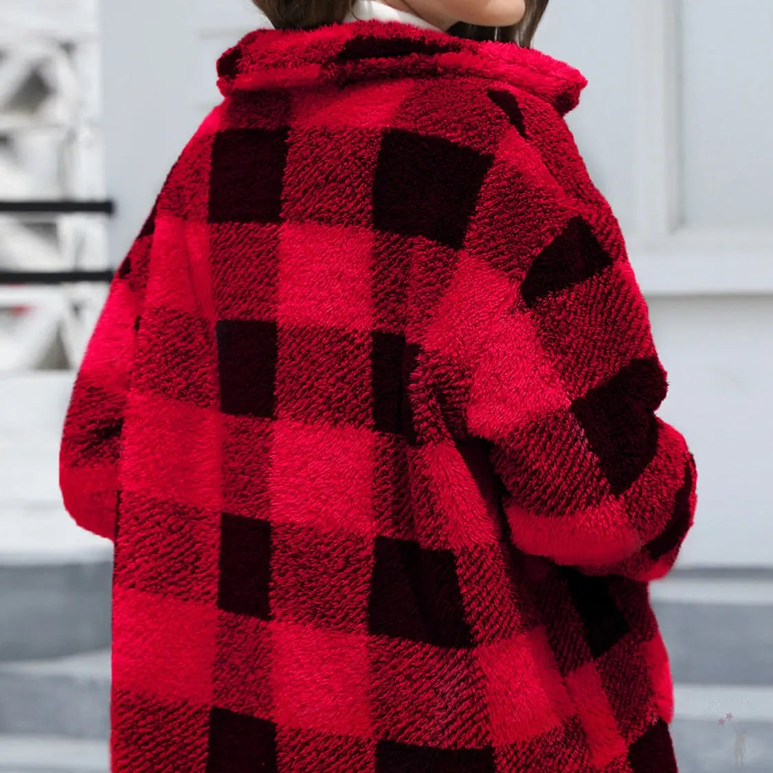 Red and black checkered coat worn by a woman showing from back view