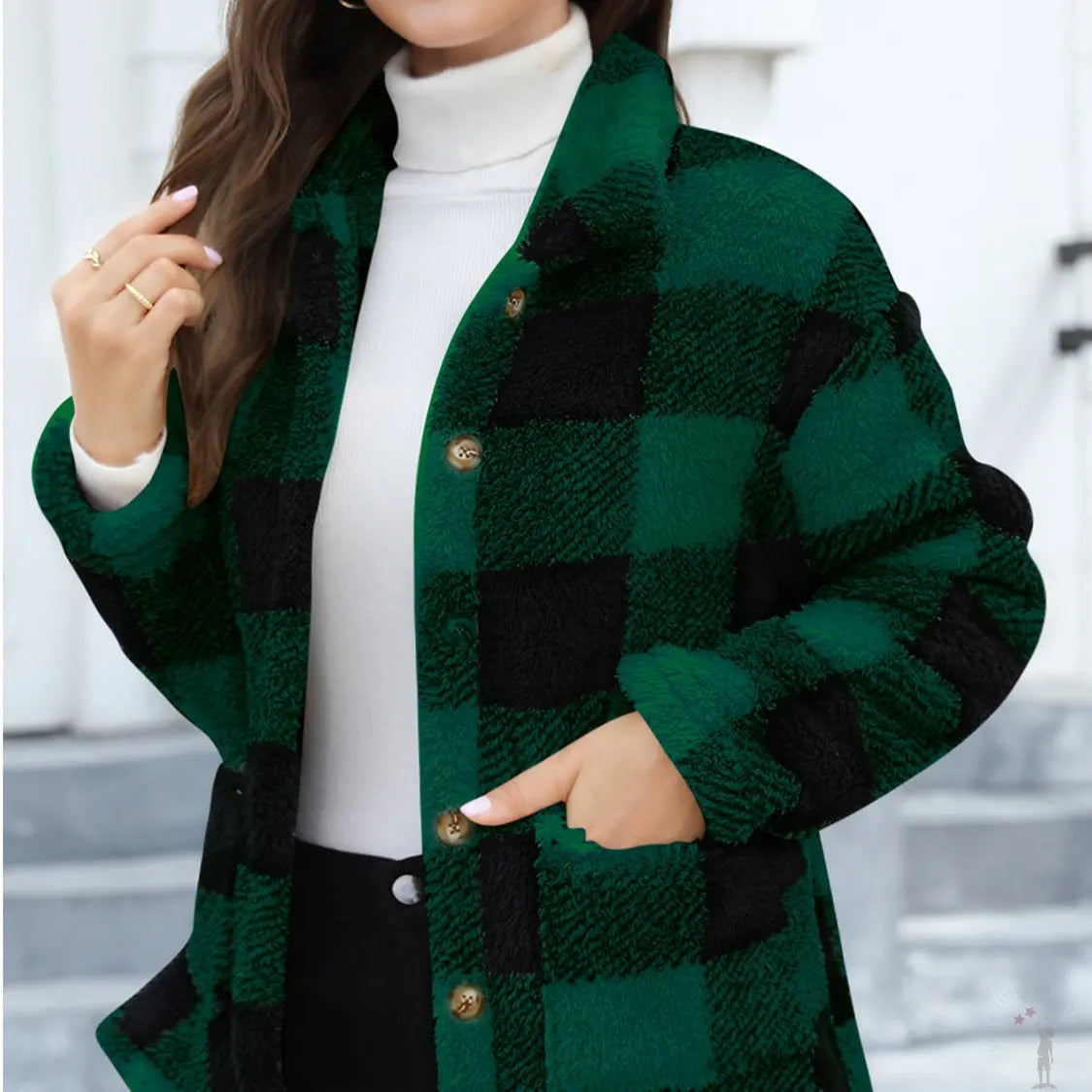 Woman wearing a green and black checkered jacket with a white turtleneck and dark pants.