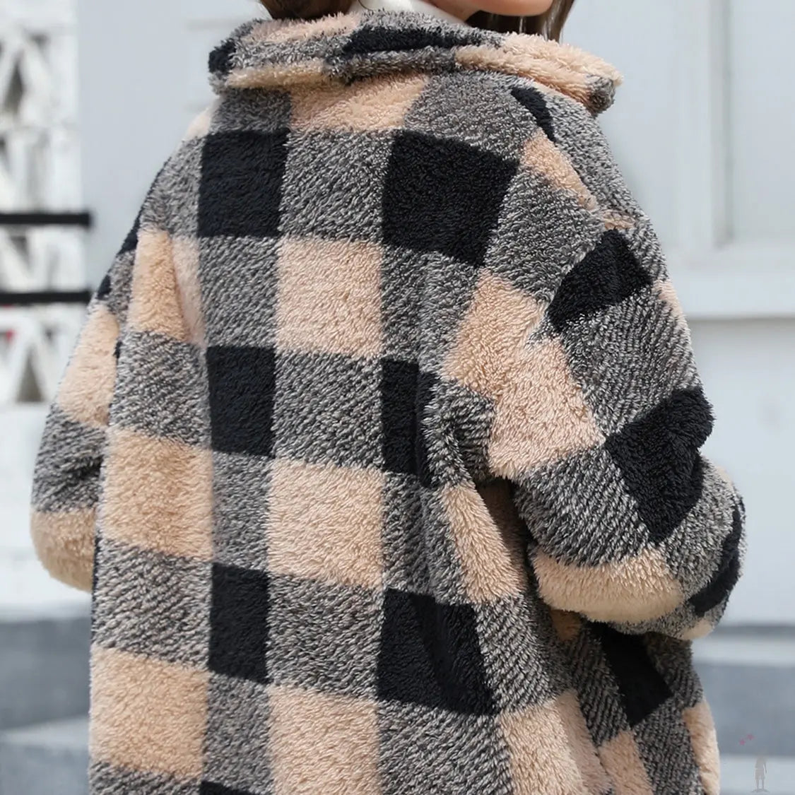 Plaid patterned coat with a checkered design in black, beige, and gray.