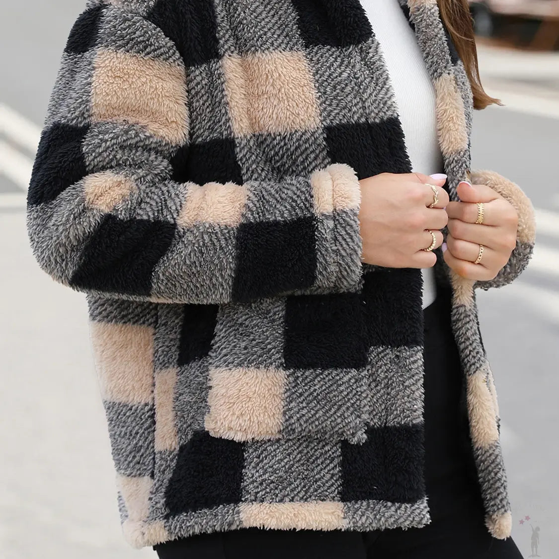 Person wearing a checkered coat with fluffy texture side view tan and black