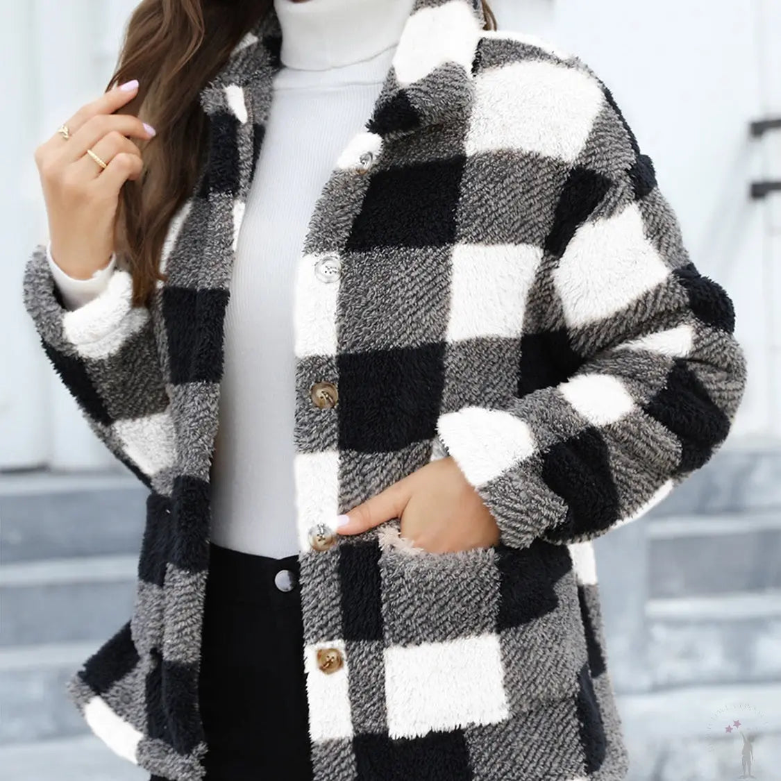Woman wearing a black and white checkered coat with a blurred background