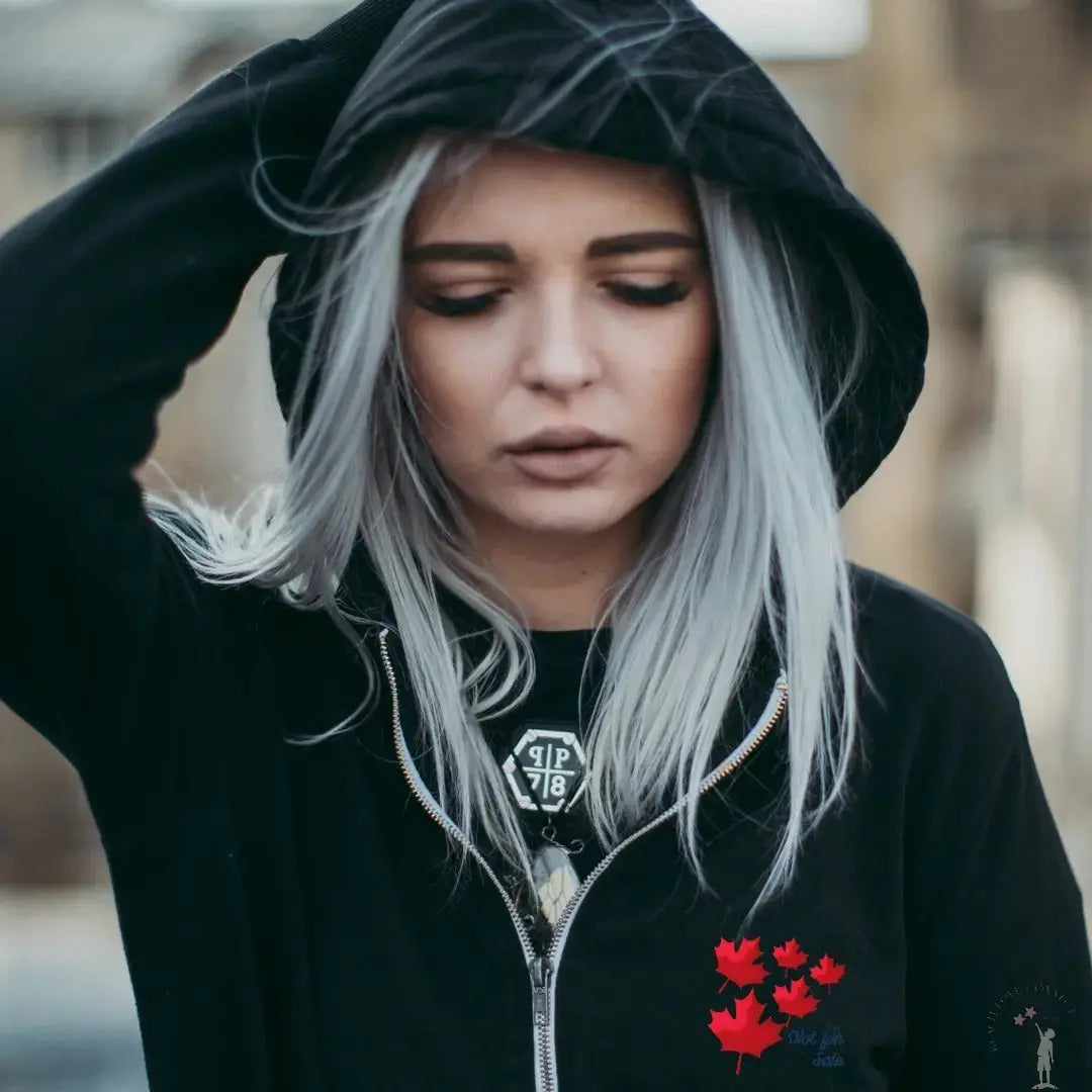 Black Canada Unisex Hoodie with bold “Canada is Not For Sale” design, cozy fleece lining, and patriotic style.