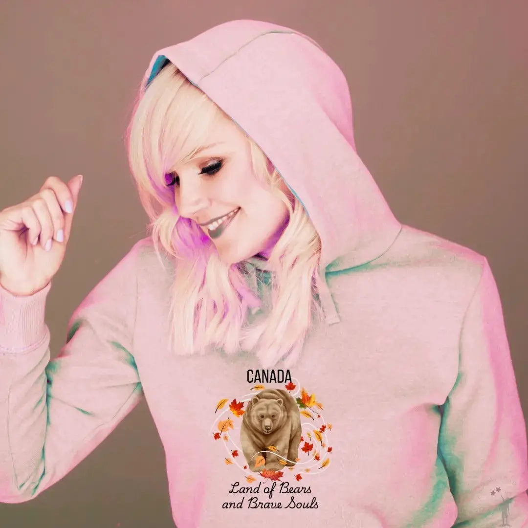 Women’s hoodie featuring Canadian bear artwork, soft polycotton blend, and stylish raw-edge finish - soft pink.