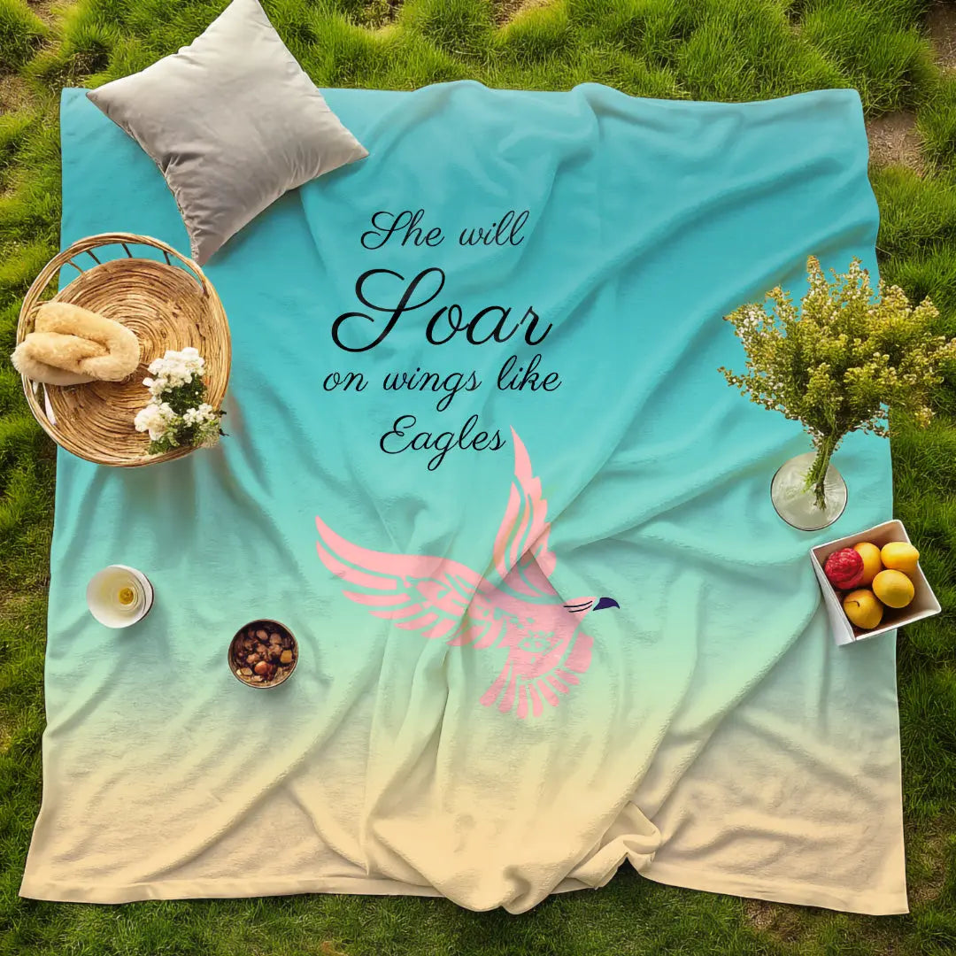 She Will Soar Woman’s Day Blanket with majestic eagle in flight on a blue background. Strength and grace theme, available at Reach Love Connect Boutique