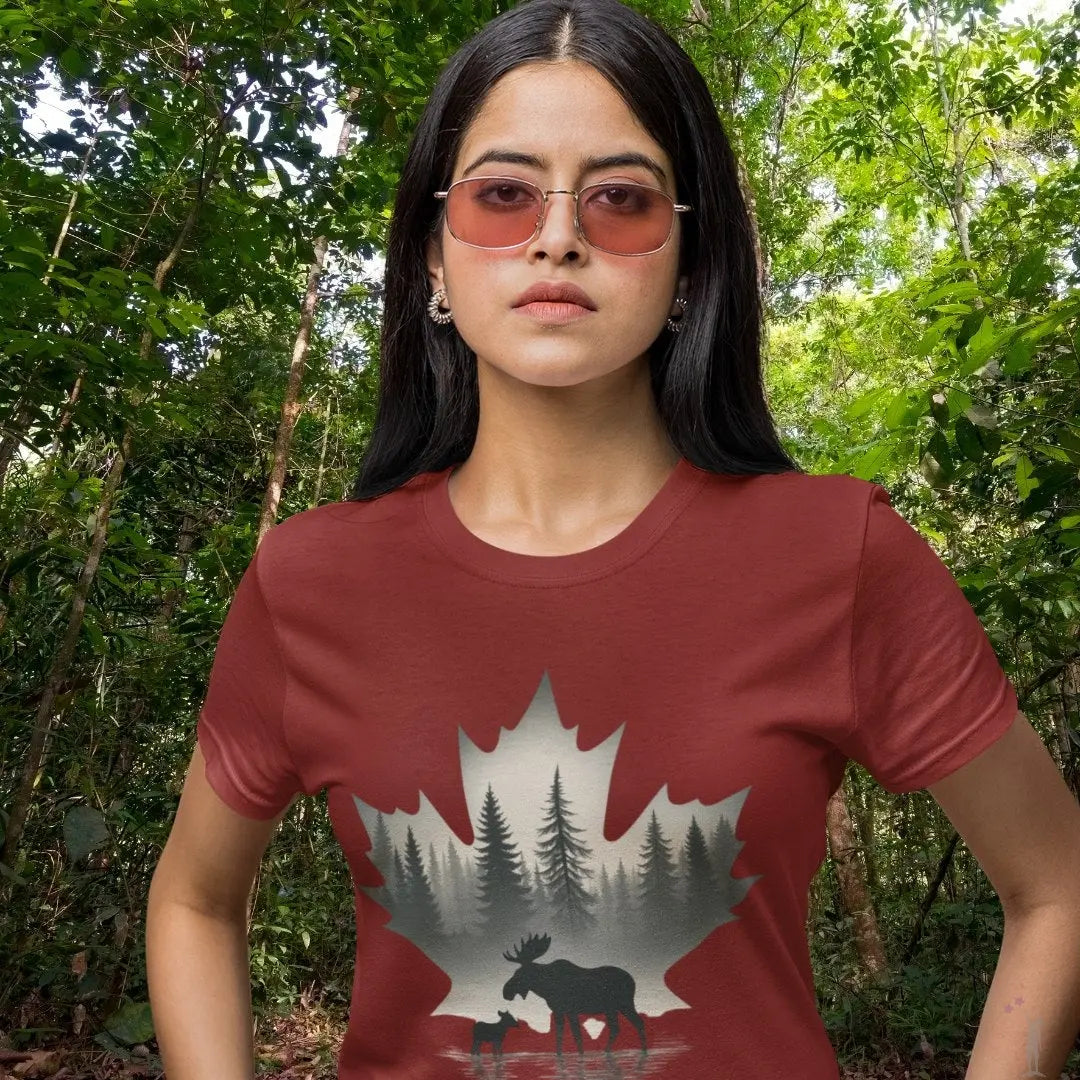 Woman wearing a red t-shirt with a nature-themed design in a forest setting