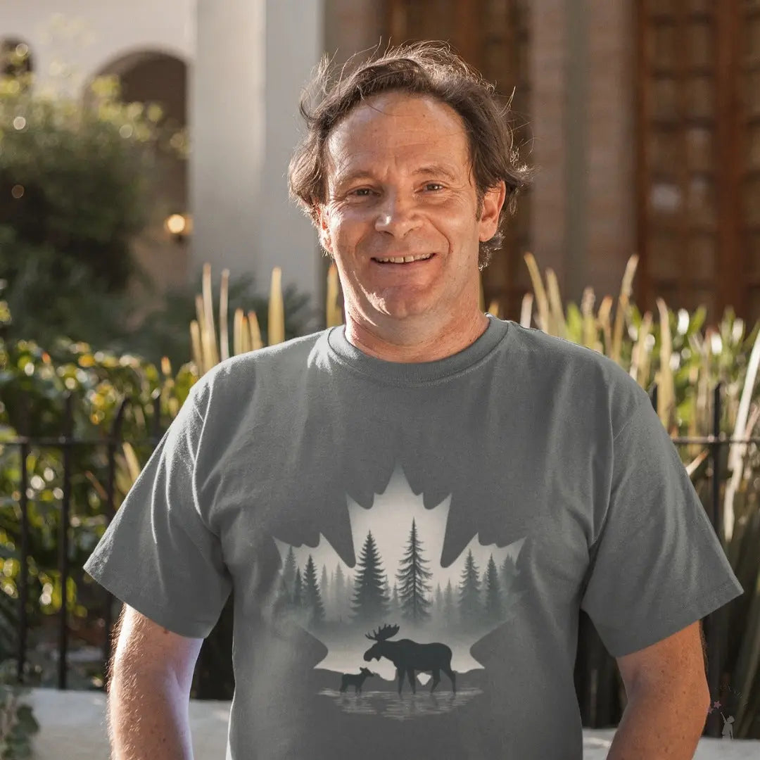 Man wearing a gray t-shirt with a nature-themed design outdoors.