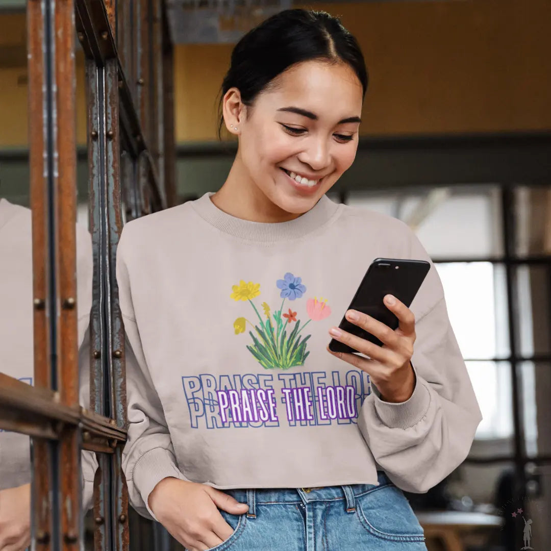 Soft blush cropped sweatshirt with flowers and Christian theme from Reach Love Connect Boutique