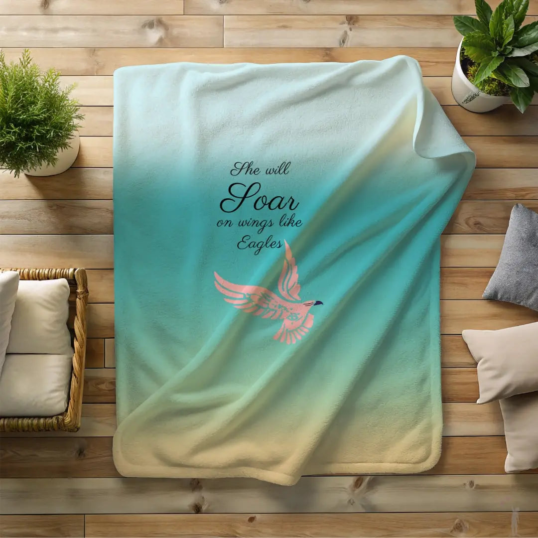 Inspirational Women’s Day blanket featuring blue hues and a soaring eagle design. Limited Edition She Will Soar blanket by Reach Love Connect Boutique.