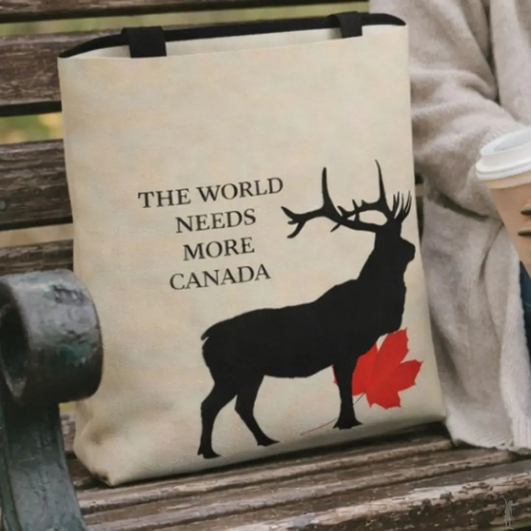 Tote bag with a deer design and text 'The World Needs More Canada' on a bench.