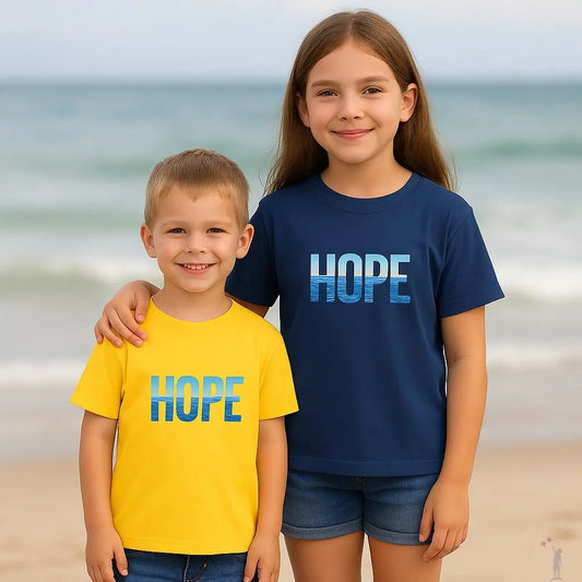 Two children wearing 'HOPE' t-shirts on a beach 2